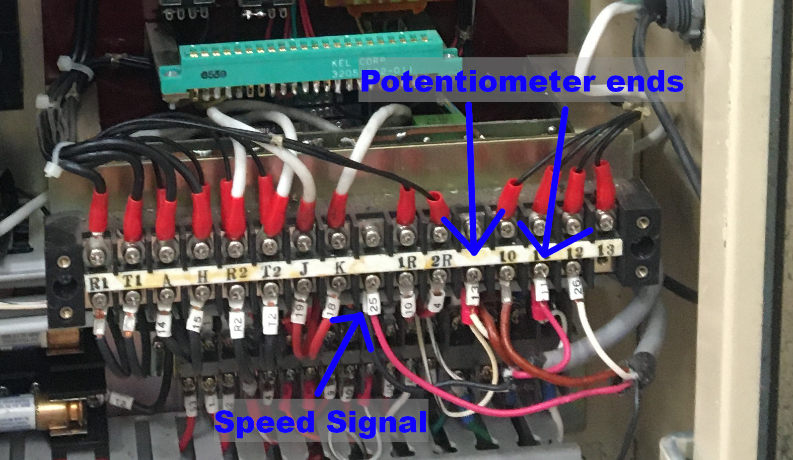 The original speed control dial wires, with the retrofitted 11V analog signal connected on the small white wires with stripes.