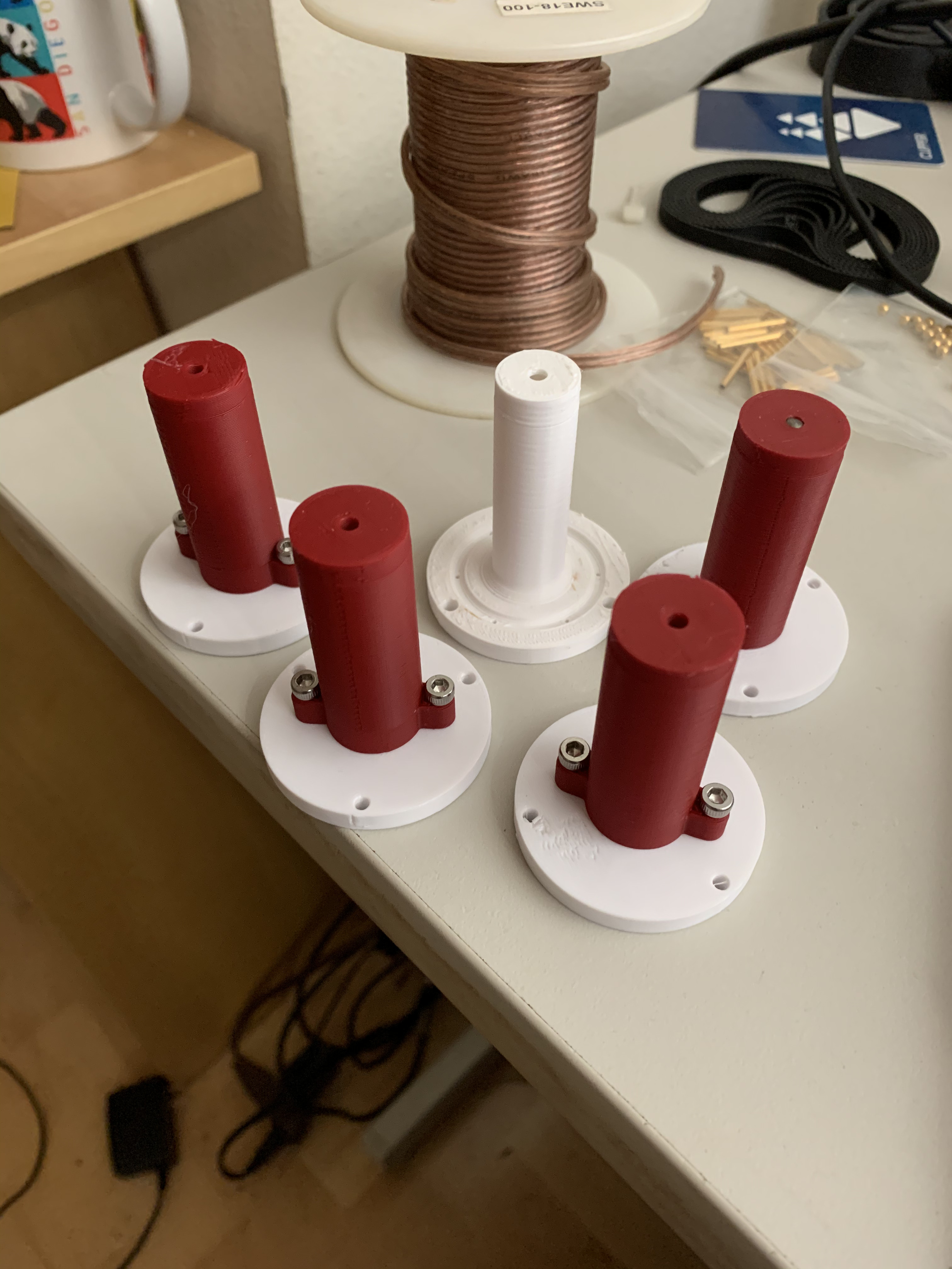 The red parts are cheap PLA while the white centers are ABS. As described above, melting the PLA with a heat gun was the most effective demold strategy I found.